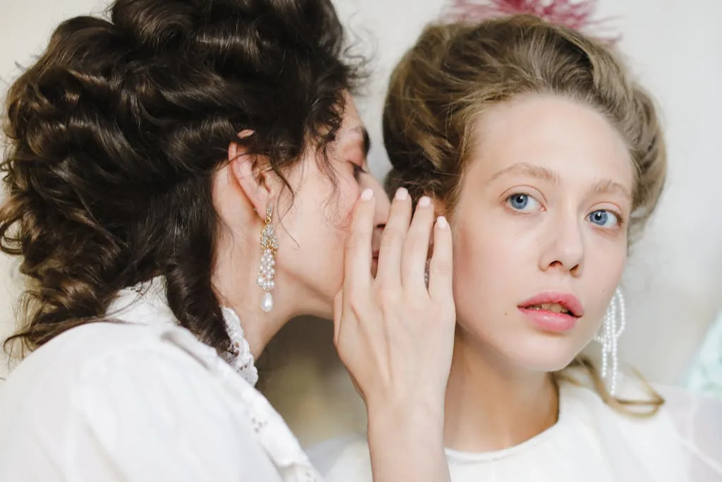 Left & Right Ear Itching Meaning, Superstition Spiritually 5 A Woman Whispering to the Ear of Another Woman